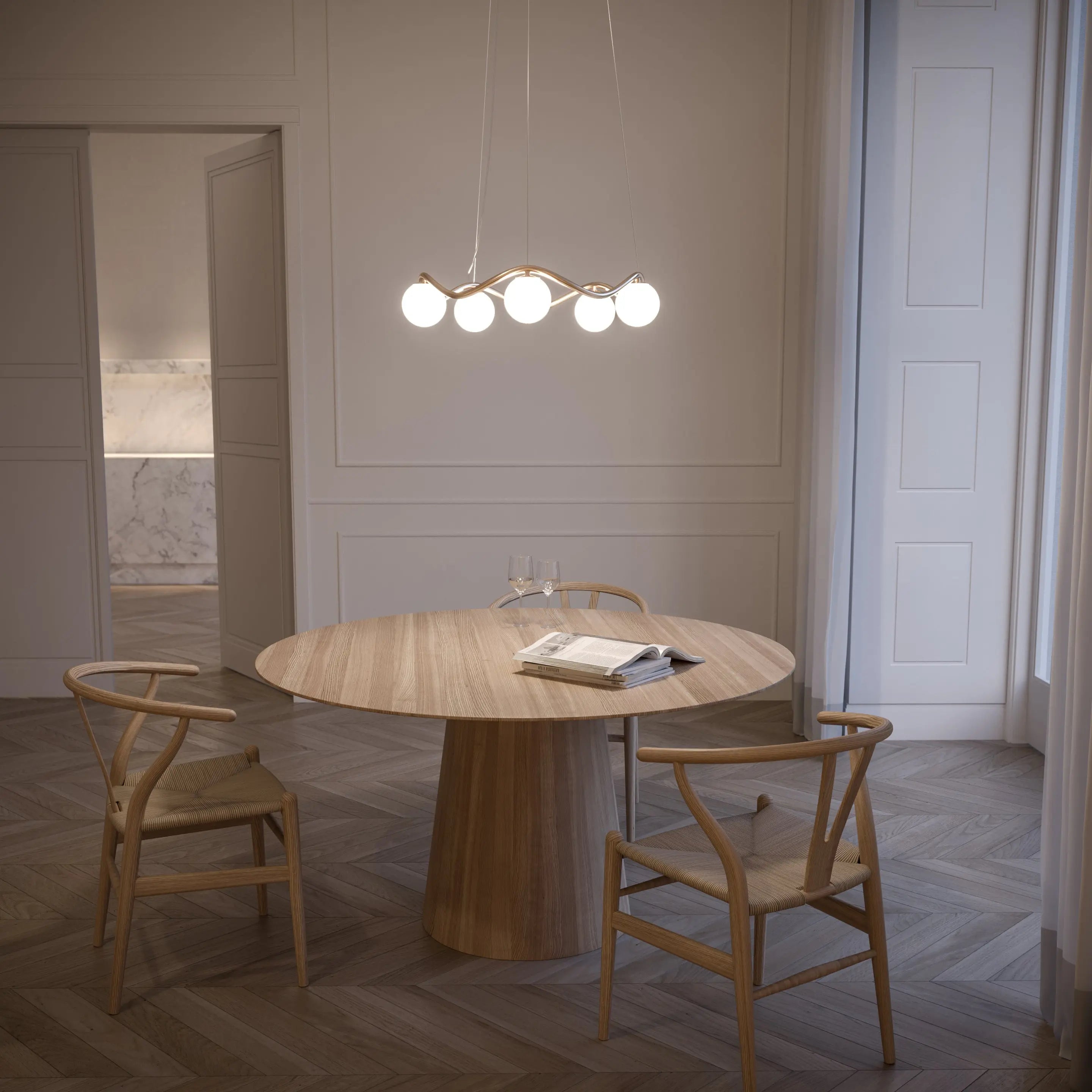 Dining area with a wooden table and chairs under a modern chandelier.