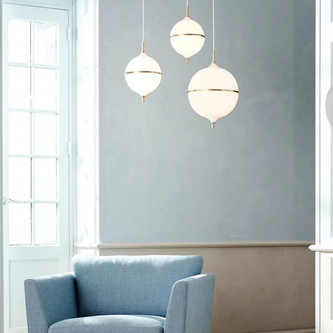 Modern living room with a blue armchair and three pendant lights.