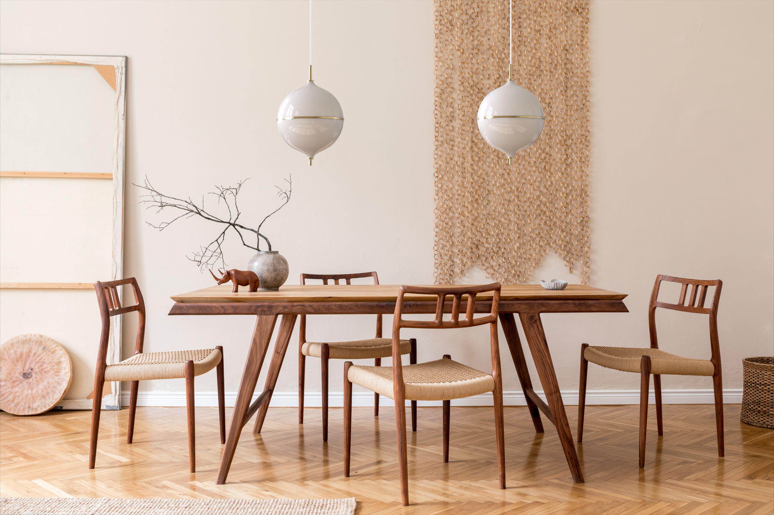 Adjustable pendant lights with sculptural brass elements for architectural lighting.