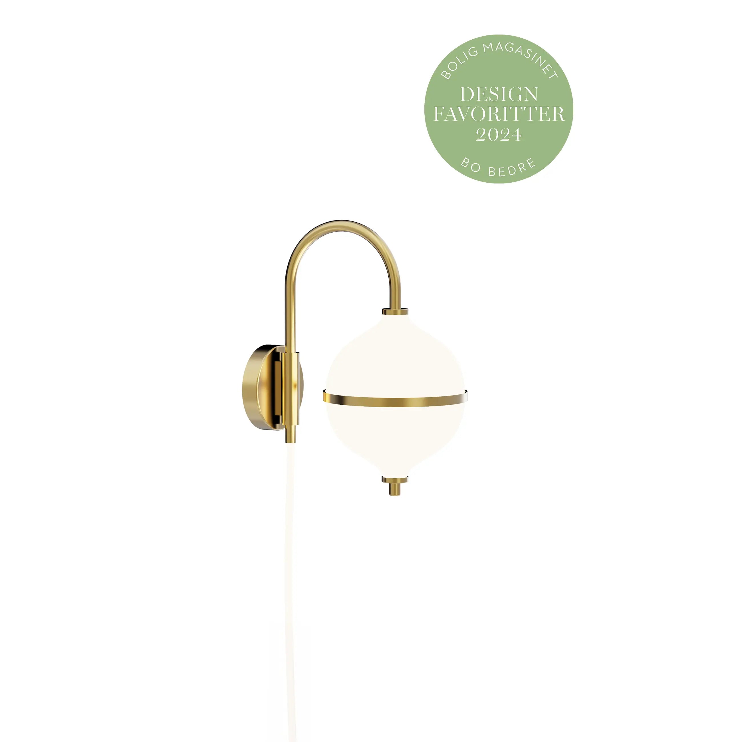 Wall-mounted lamp with gold fixture and white globe on a white background, featuring a 'Design Favorite 2024' badge.