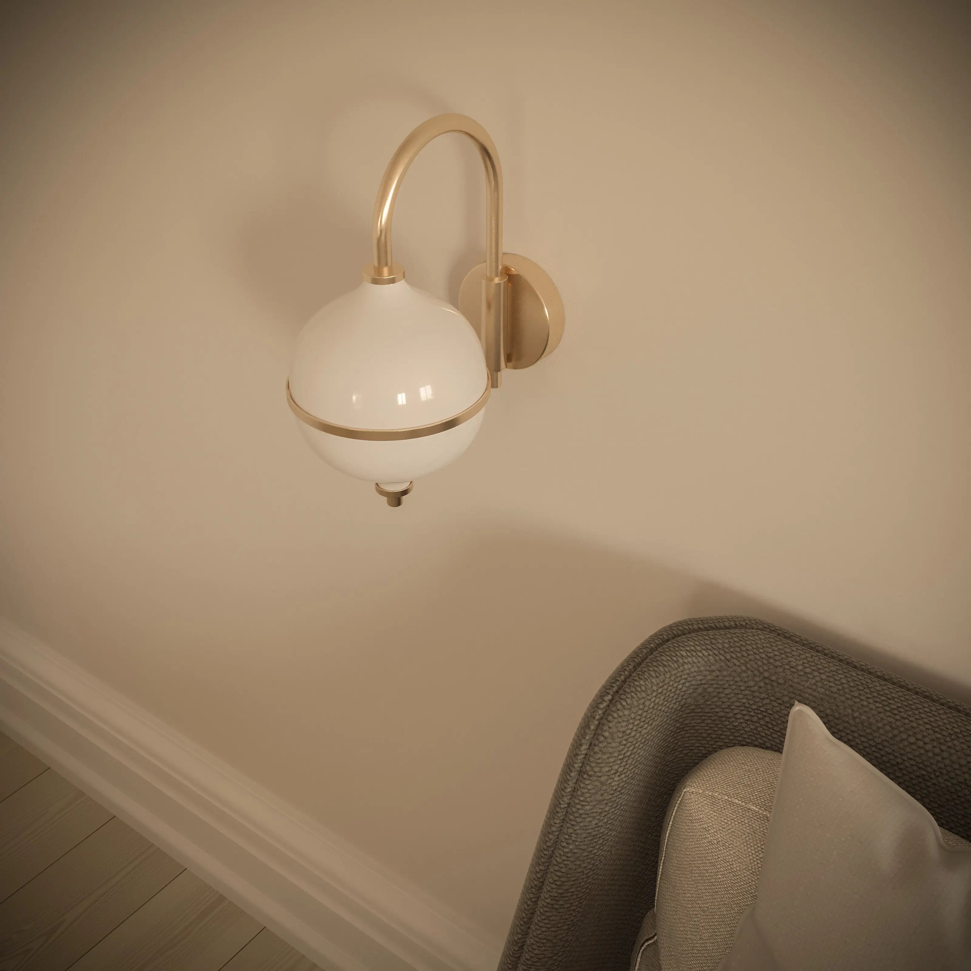Wall-mounted light fixture with a white globe and gold accents on a beige wall.